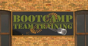 A sign mounted on a yellow brick wall between two windows reads 