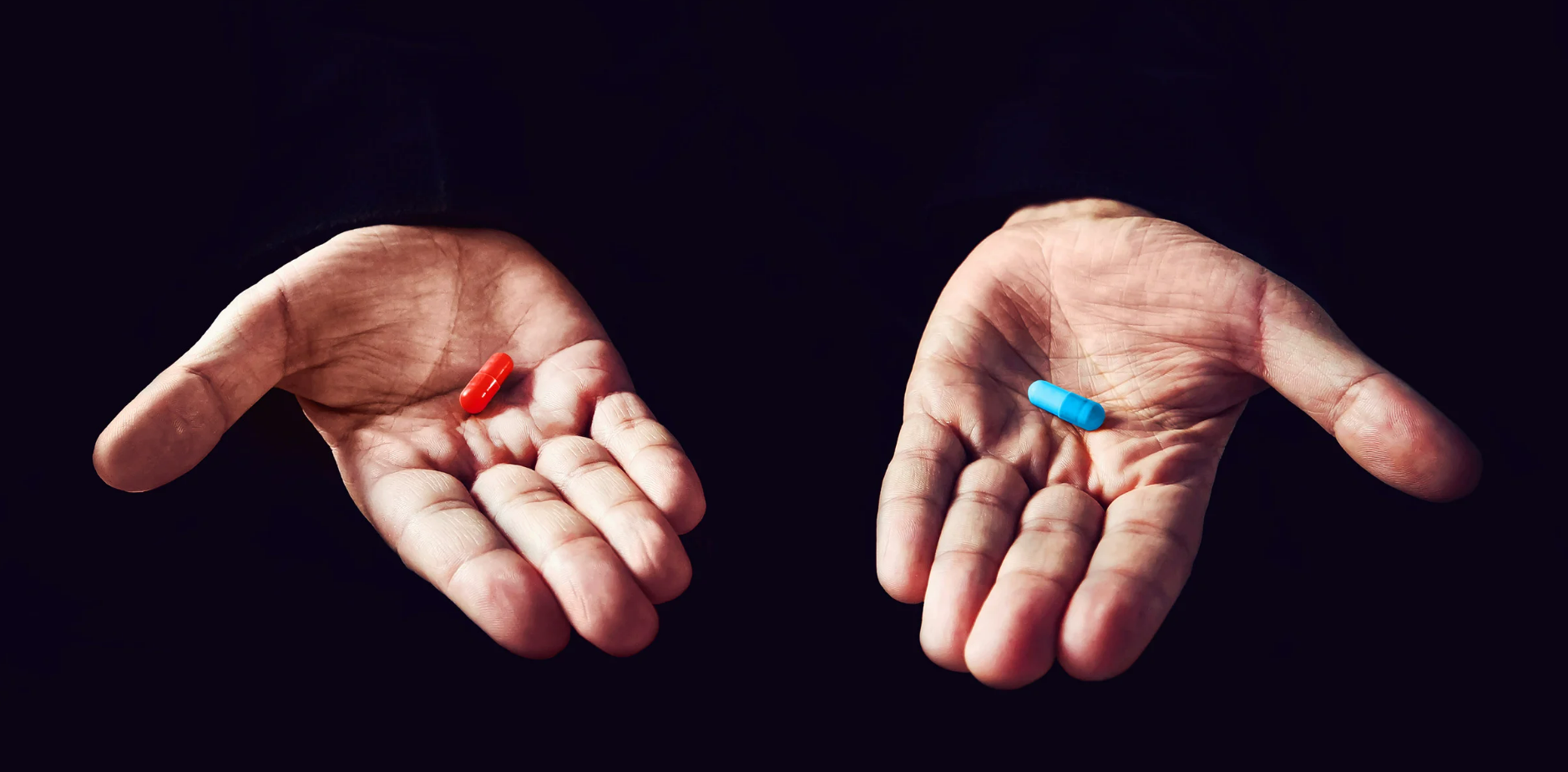 Two hands holding pills like in the matrix