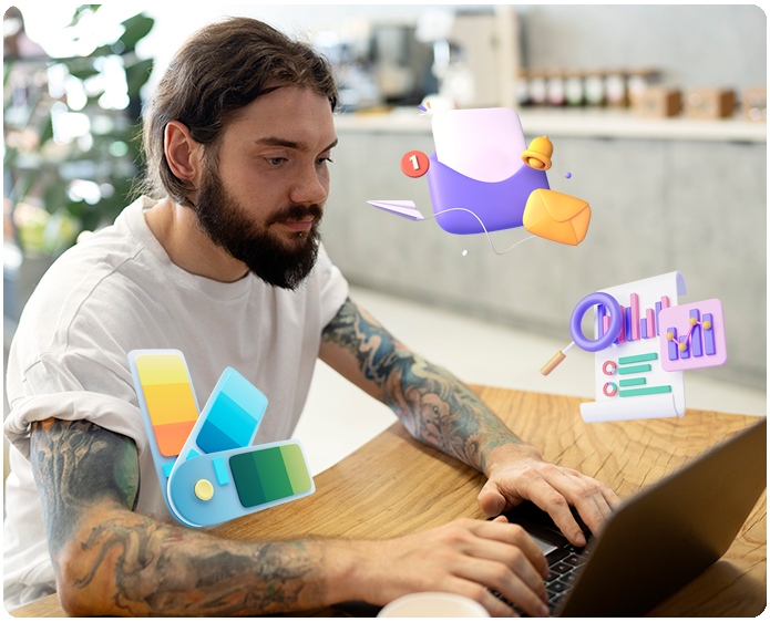 Skægget mand arbejder på bærbar computer med ikoner for digital markedsføring.